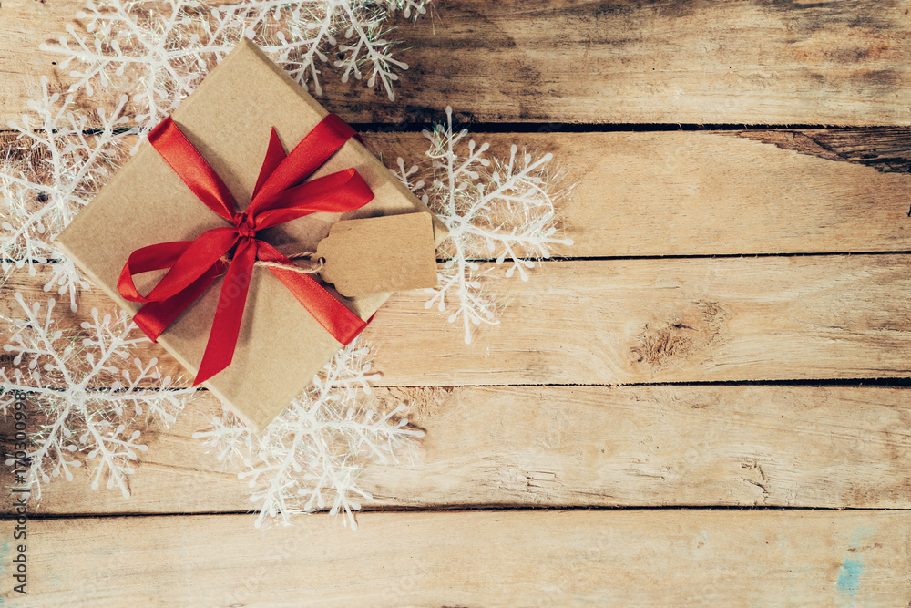 Christmas gift boxes placed and white snowflakes on wooden planks with space. Christmas gift boxes placed and white snowflakes on wooden planks with space.
