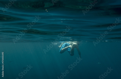 Man swimming underwater © davidaguerophoto