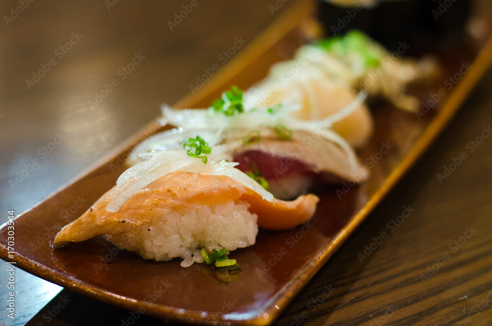 Japanese cuisine salmon aburi sushi. salmon burn with mayo sauce on plate Japanese cuisine salmon aburi sushi. salmon burn with mayo sauce on plate