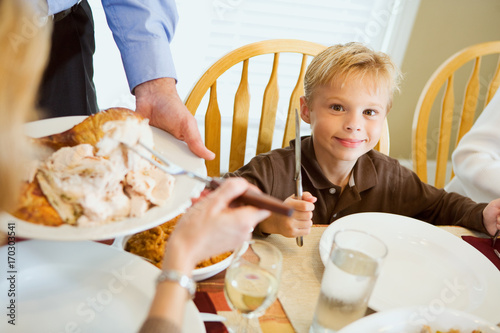Slika na platnu Thanksgiving: Hungry Boy Holds Silverware While Waiting For Dinner