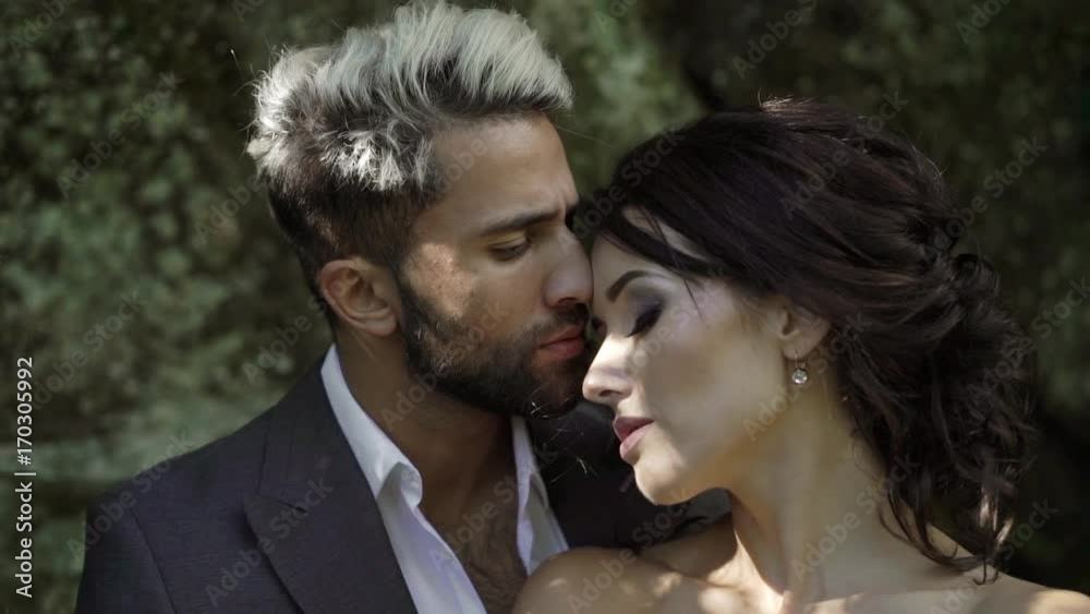Young couple embracing in park slowmotion Young couple embracing in park slowmotion
