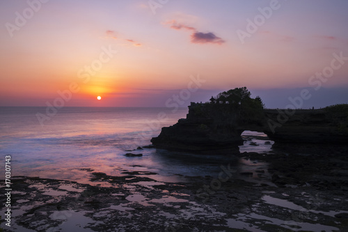 Silhouette temple on a strong cliff in a beautiful twilight at Pure Batu Bolong, Bali, Indonesia