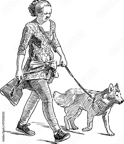 A city woman walks with her dog