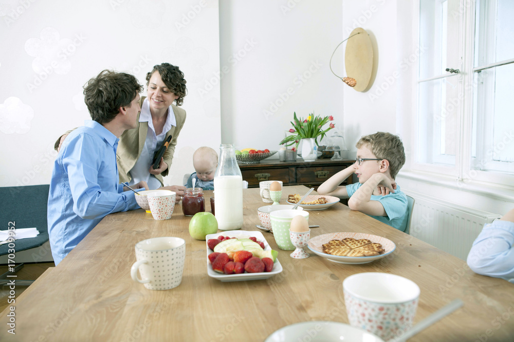 Family with three children having breakfast Family with three children having breakfast