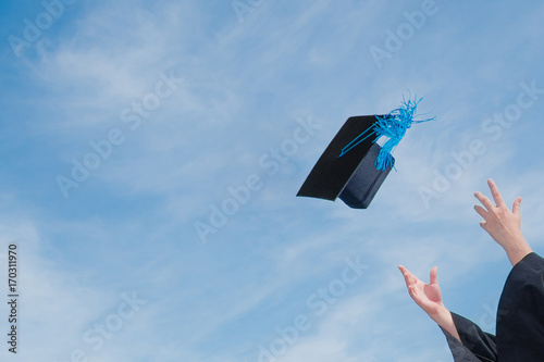 Graduate success celebration throw graduation cap in the sky concept background with copy space