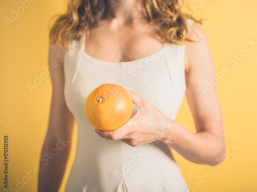 Young woman with grapefruit