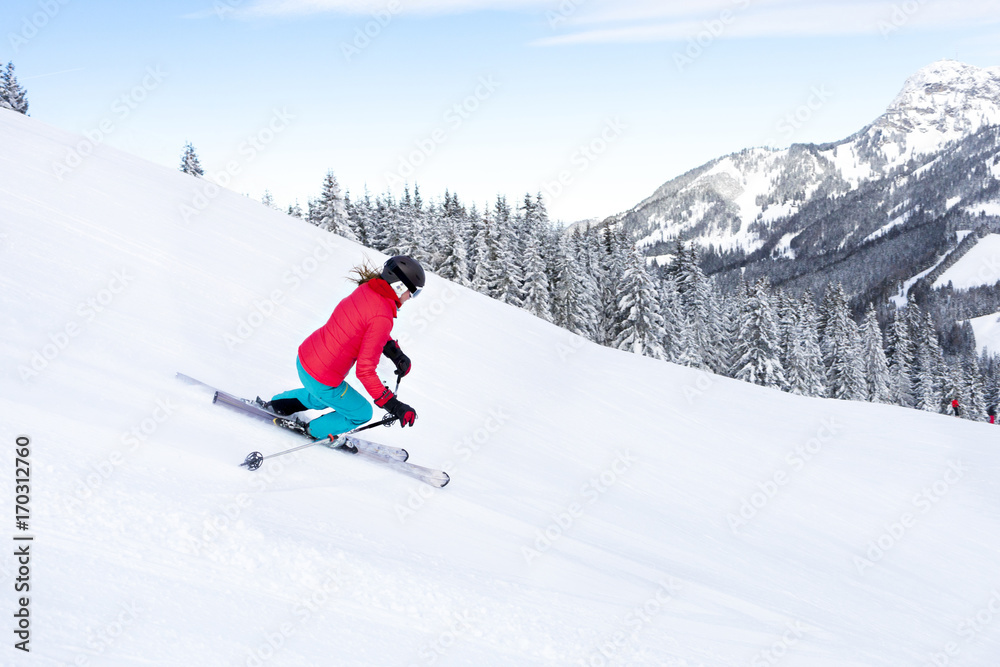 Ski holiday, Woman skiing downhill, Sudelfeld, Bavaria, Germany Ski holiday, Woman skiing downhill, Sudelfeld, Bavaria, Germany