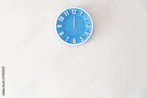 noon or midnight time with 12:00 clock on white concrete wall interior background with copy space, message board concept. Noon is the lunch time , Midnight is the bed time