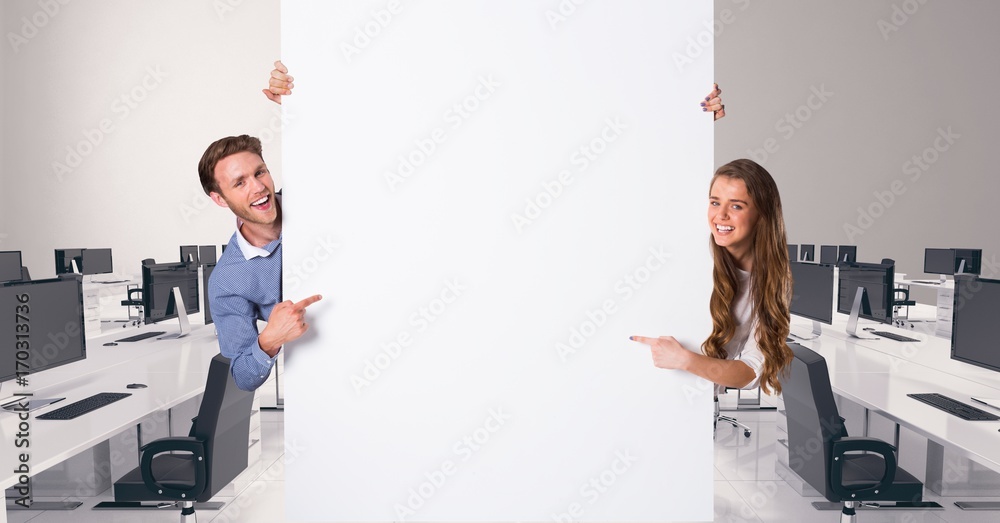 Business people holding blank card in office Business people holding blank card in office