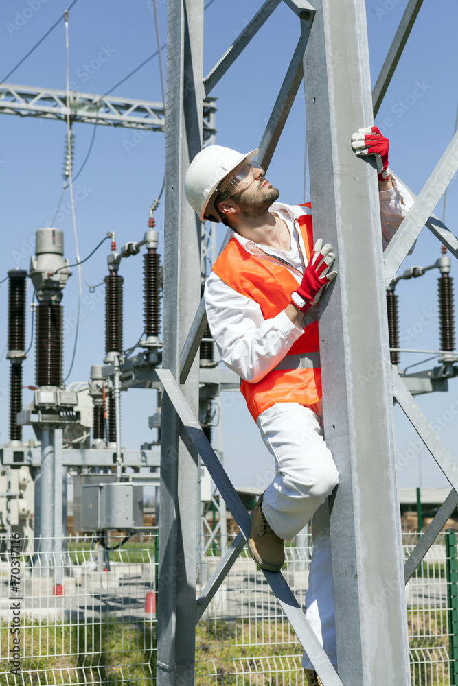 Engineer climbing electricity pylon Engineer climbing electricity pylon