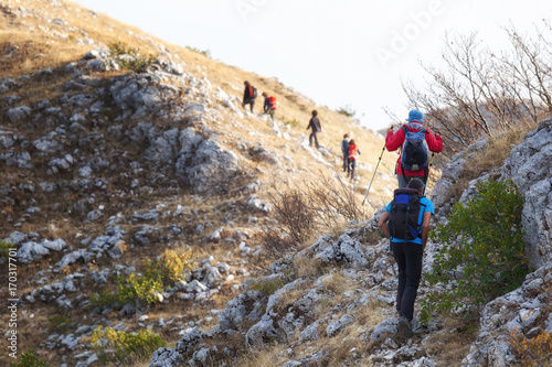 Group of hikers scales the rocks of a mountain