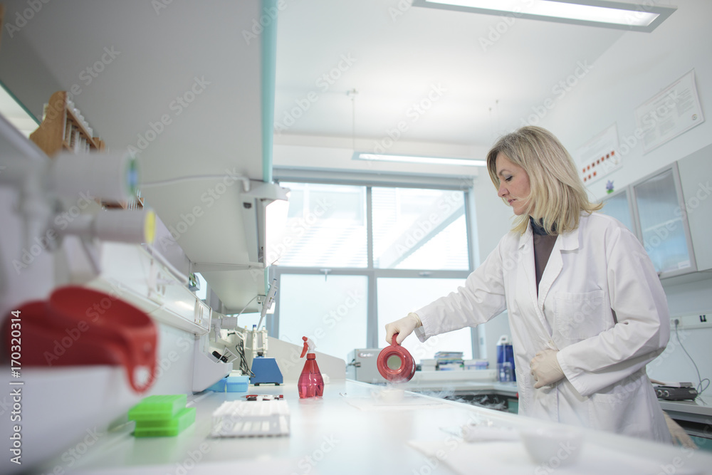 Female scientist doing an experiment in laboratory Female scientist doing an experiment in laboratory