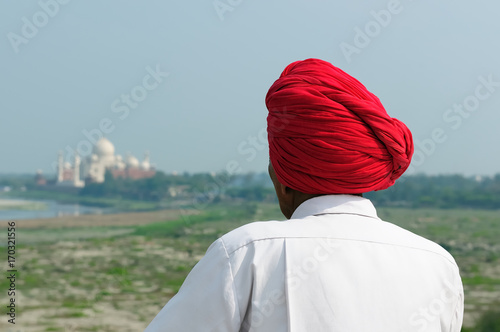 The Indian in the turban is looking from Red Fort on Taj Mahal photo