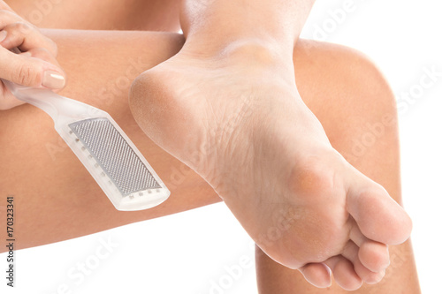 фотографія Female feet and callus remover tool