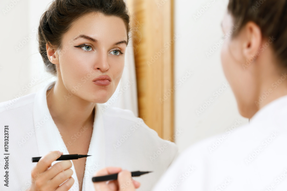 Woman is disappointed with her skill of applying makeup Woman is disappointed with her skill of applying makeup