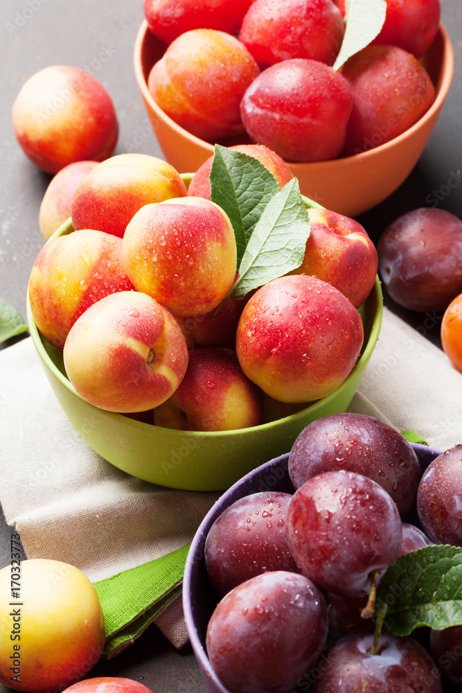 Fresh ripe peaches and plums Fresh ripe peaches and plums