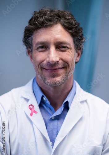 Doctor man with breast cancer awareness ribbon © vectorfusionart