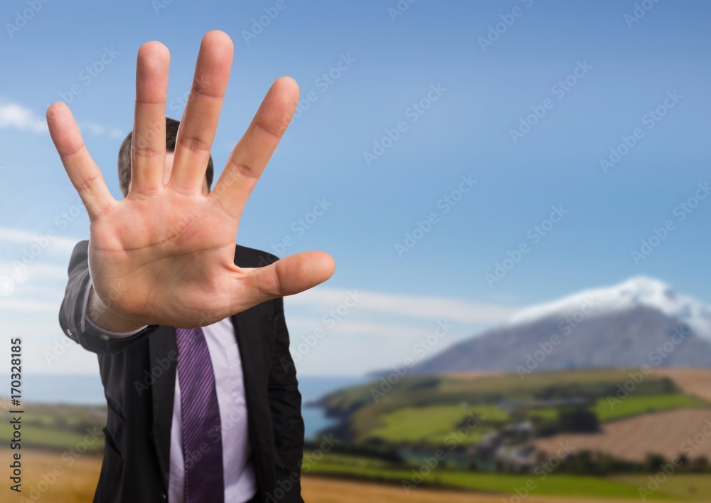 Businessman in nature with hand signal to stop Businessman in nature with hand signal to stop