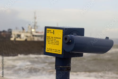 A close up of a coin operated telescope in a strong metal casing on the North Pier in Bangor County Down