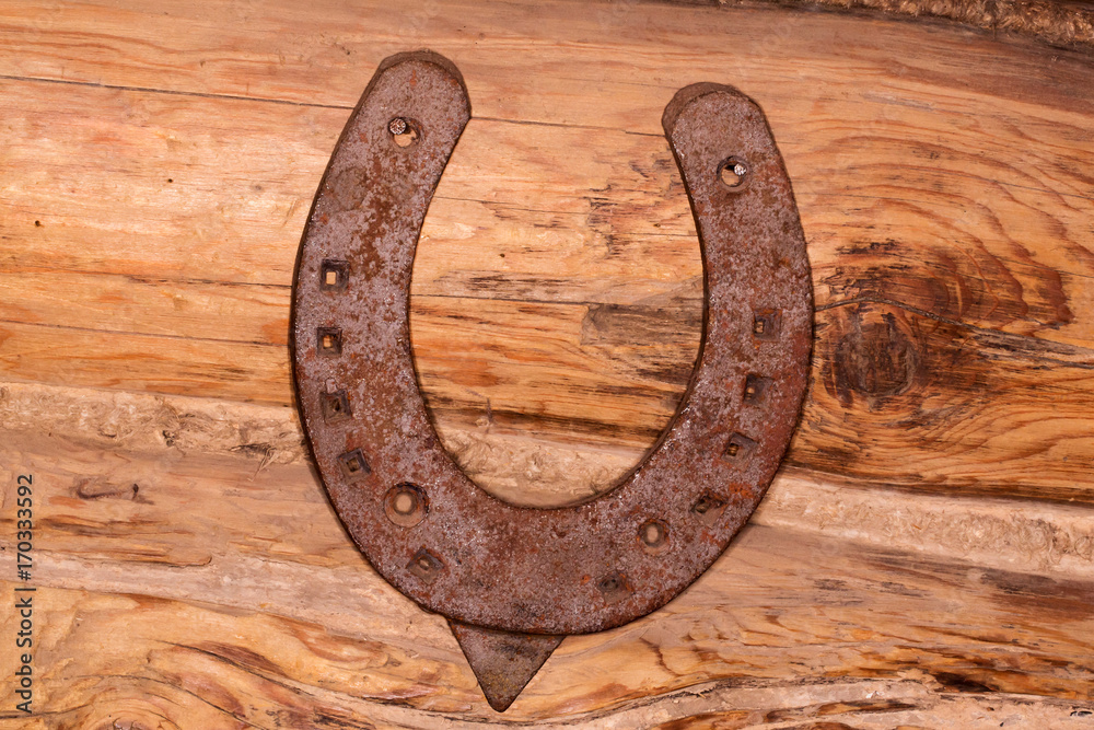 steel horseshoe on wooden background steel horseshoe on wooden background