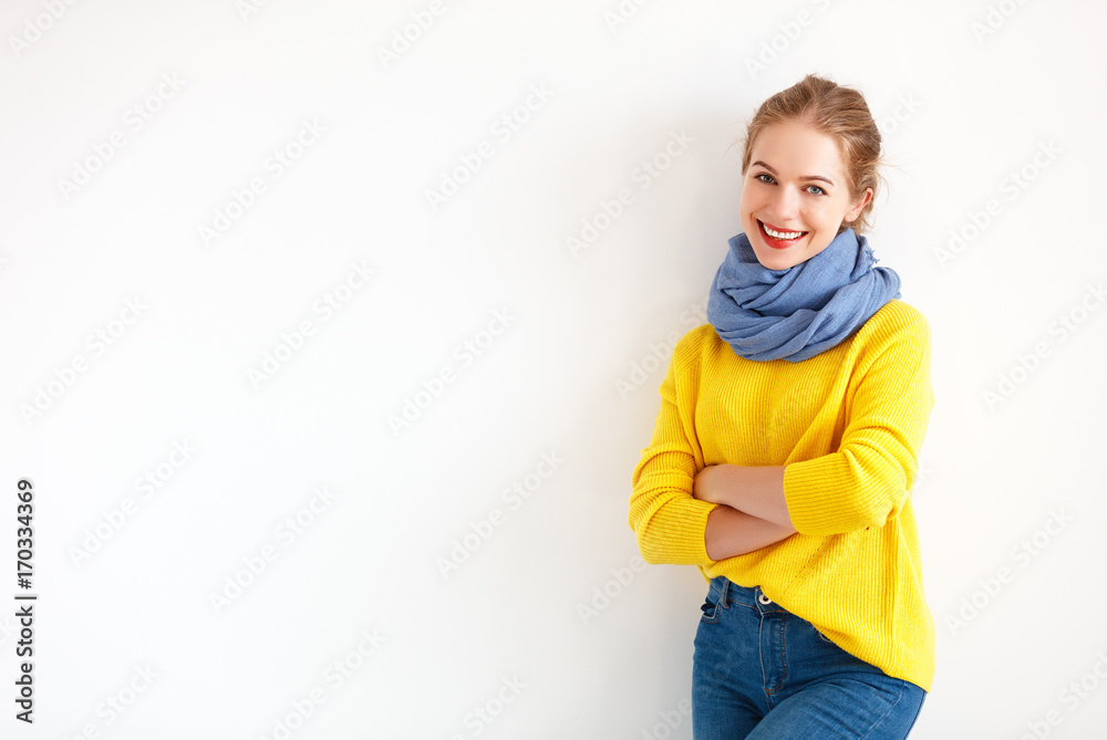 happy young woman in yellow sweater on white background.