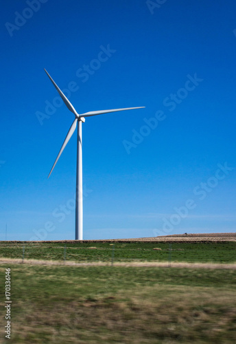 Vertical image of a single wind turbine.
