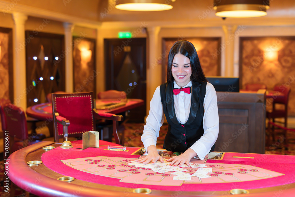 Cute lady casino dealer at poker table. Cute lady casino dealer at poker table.
