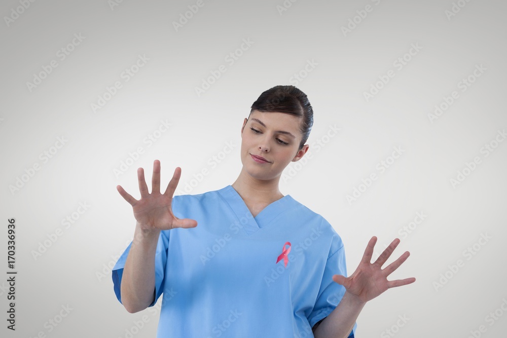 Doctor woman with breast cancer awareness ribbon Doctor woman with breast cancer awareness ribbon