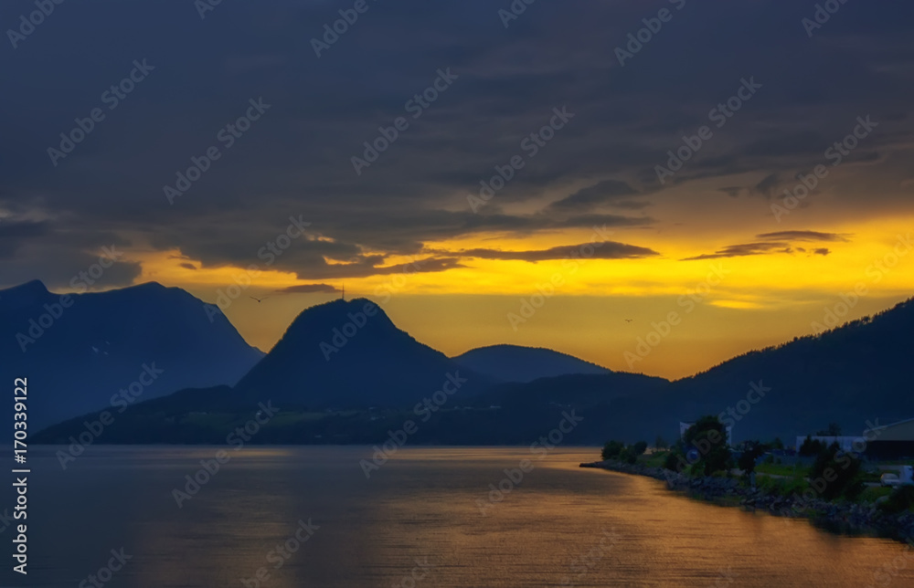 beautiful and dramatic Norway landscape with mountains and sea in fjord
