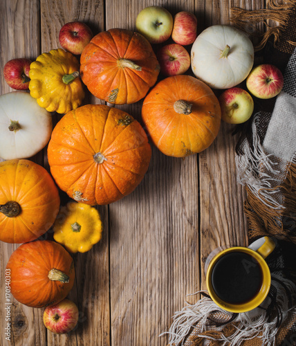 Cup of coffee and some pumpkins on wood background