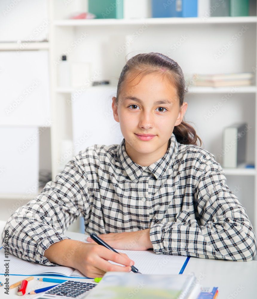 Teenage girl preparing for exams. Teenage girl doing homework for school.. Teenage girl preparing for exams. Teenage girl doing homework for school..