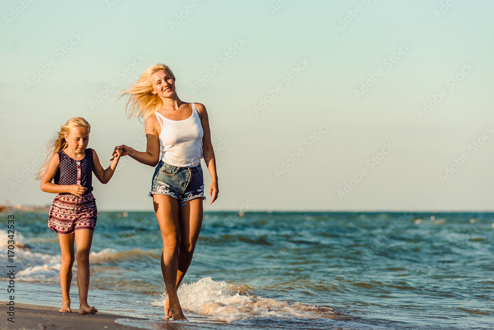 Fototapeta premium Happy family during summer vacation on against the sea, ocean