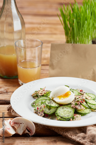 Felicious and fresh salad with cucumber, eggs and seeds.