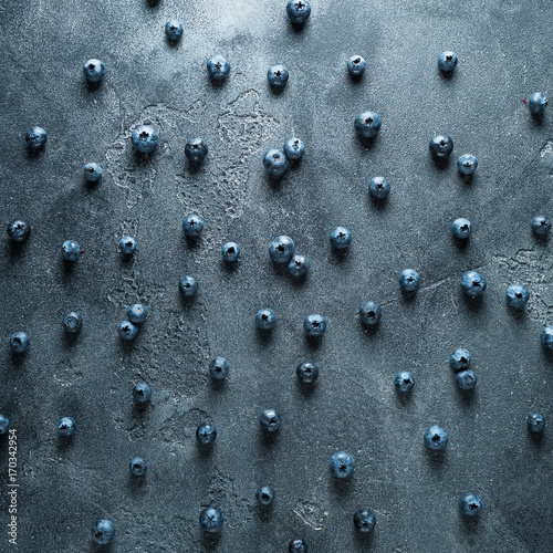 Pattern of blueberries on dark background. Food background. Flat lay, top view