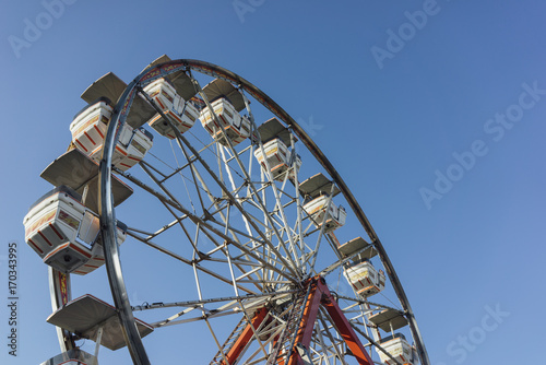 Ferris wheel against a blue sky at a carnival