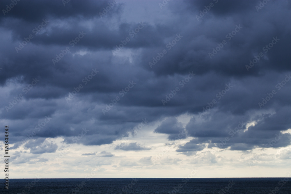 Black storm clouds over the dark sea.
