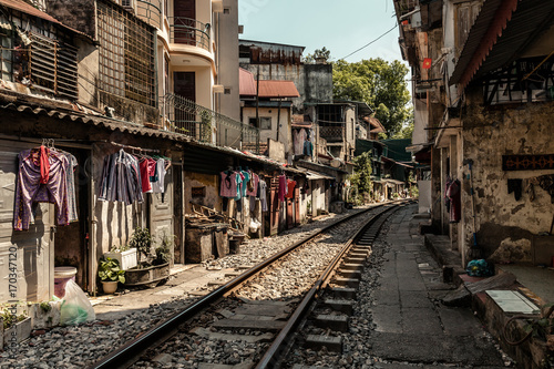 Train passing through Hanoi streets and houses
