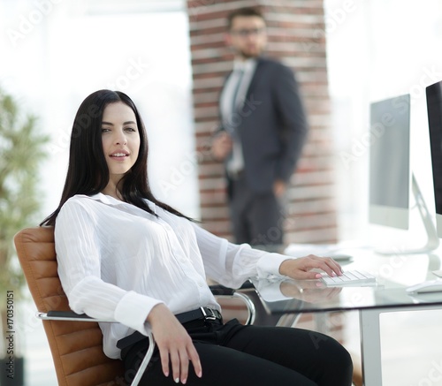 successful young business woman sitting at workplace