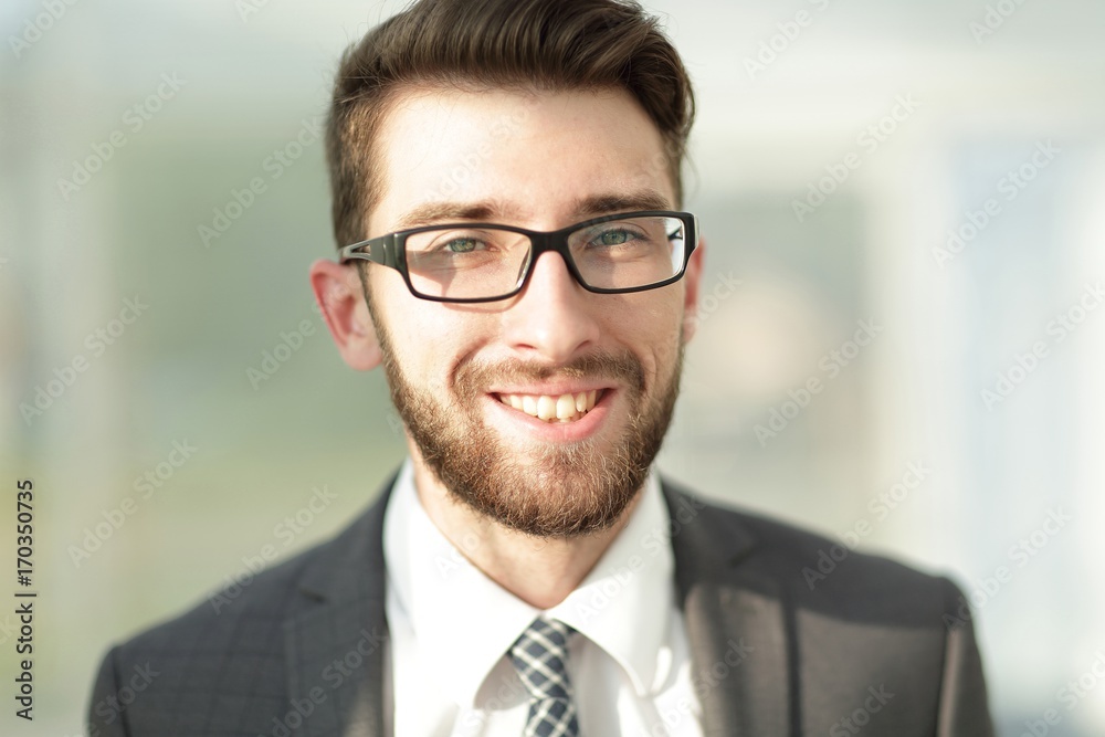 Portrait of a modern businessman sitting at his desk. Portrait of a modern businessman sitting at his desk.