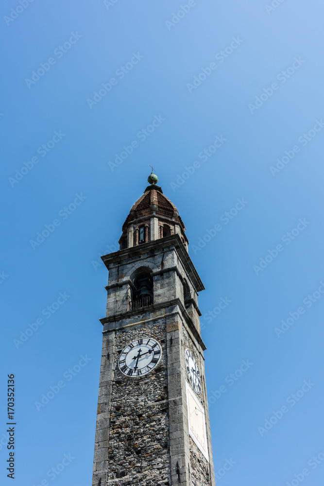 Historic Clock tower of Chiesa Parrocchiale dei Santi Pietro e Paolo Locarno, Switzerland with blue sky