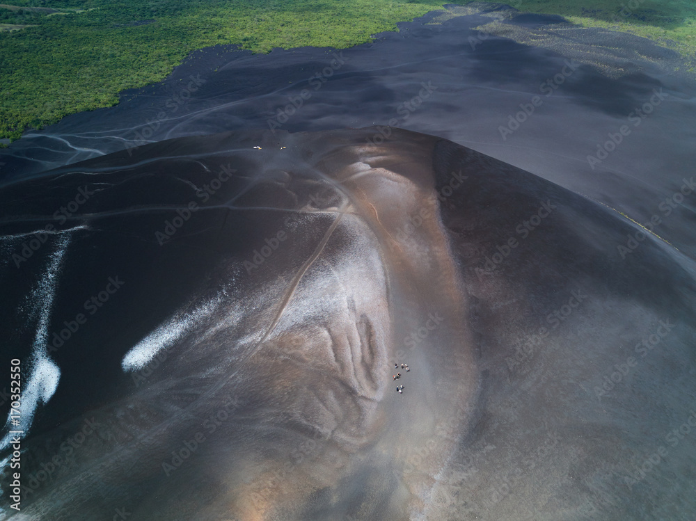 Fototapeta premium People walk on volcano ash