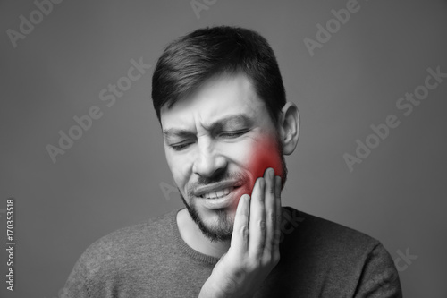 Handsome man suffering from...