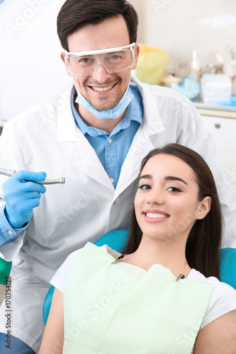 Young woman and male dentist in clinic