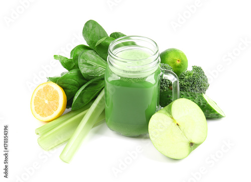 Mason jar of green healthy juice with vegetables and fruits on white background