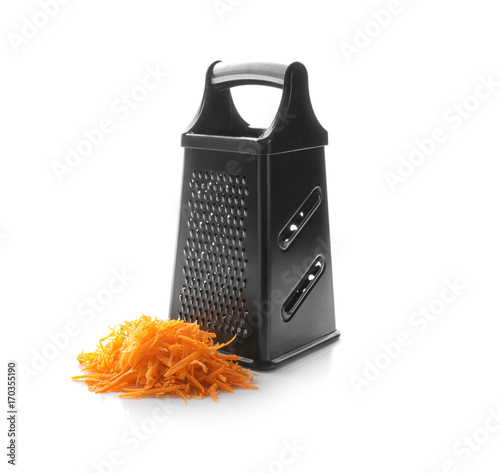 Metal grater and carrot on white background