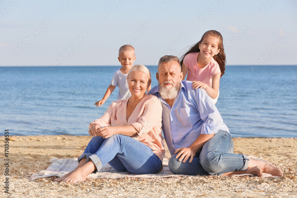 Cute children with grandparents on sea beach Cute children with grandparents on sea beach
