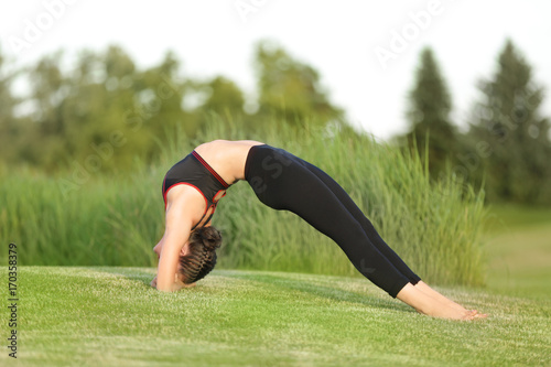 Young woman practicing yoga in park