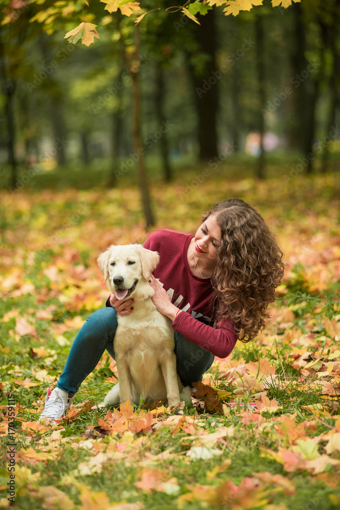 Beautiful smiling woman with cute golden retriever dog
