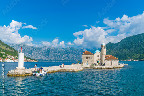 MONTENEGRO - JUNE 04/2017. Tourists sailed on a yacht to the island of Gospa od Skrpela in the Boka Bay of Kotor. photo