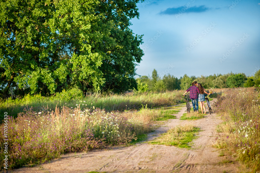 couple riding bikes, embracing and kissing couple riding bikes, embracing and kissing